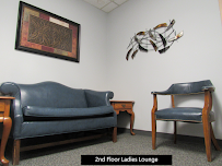 Second floor lounge with sofa, armchair, and framed art