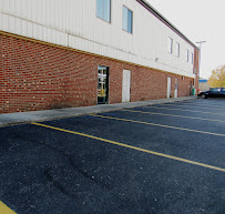 Freshly striped parking spaces along the brick rear of the building
