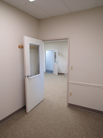 Open suite door leading into a multi-room office space